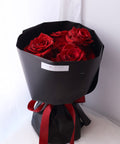 Red rose-only bouquet in black wrapping with red and black ribbons