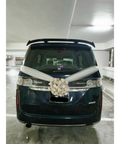 White floral wedding car arrangement with ivory ribbons on a dark van
