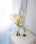 White calla lily bridal bouquet and matching boutonniere with looped grass and white ribbon